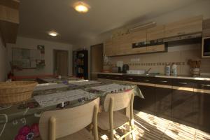 a kitchen with a table and chairs and a counter at Ubytování ALJA in Jeseník