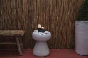 a white toilet with candles on it next to a fence at Suites The Marcel in Sète