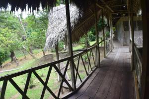 a porch of a building with a wooden walkway at Lodge Jungle Wolf Expeditions in Yucuruche