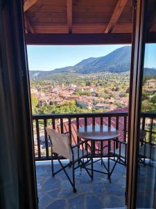 a table and chairs on a balcony with a view at Panorama Vytinas in Vytina