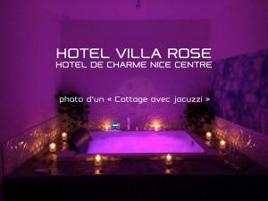 a purple room with a pool with lights in it at Hotel Villa Rose in Nice