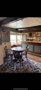 a dining room with a table and two chairs at THE RED LION in Cricklade