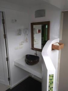 a bathroom with a black sink and a mirror at Mama Beach Residence- SHA Certified in Phi Phi Islands
