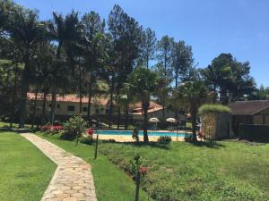 a resort with a swimming pool in a yard at Recanto Caminho das Águas in Caxambu
