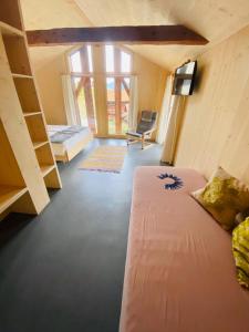 a bedroom with a bed and a chair in a room at ViVa B&B Urmein in Urmein