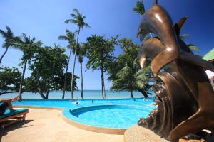 a statue next to a swimming pool at a resort at Cookies Hotel in Ko Chang