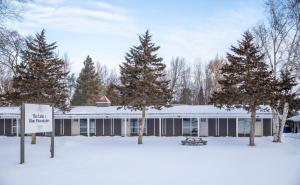 a building in the snow with trees in front at Boutique Suite #5 in Blue Mountains