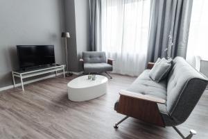 a living room with a couch and a chair at Stylisches Münster City-Apartment 56 m² in Münster