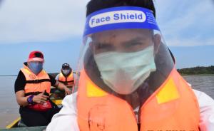 a man in a boat wearing a face mask at Lodge Jungle Wolf Expeditions in Yucuruche