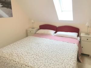 a bedroom with a bed and two night stands at Ferienwohnungen im Haus Borée in Prerow
