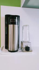 a coffee maker and a blender on a shelf at Bed and Pool in Oberursel