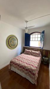 um quarto com uma cama e uma janela em Pousada Travessias em Tiradentes