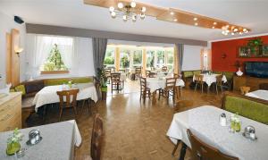 a restaurant with tables and chairs and a dining room at Pension Fischinger in Feldkirchen in Kärnten