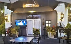 a patio with a table and a tv in a building at Cozy Aqua Private Suite with Parking in Miami