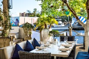 a table with chairs and wine glasses on a patio at Cozy Aqua Private Suite with Parking in Miami