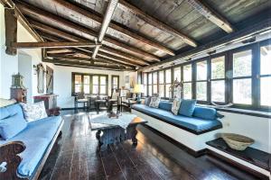 a living room with blue couches and a table at Ampelos Estate in Akrata