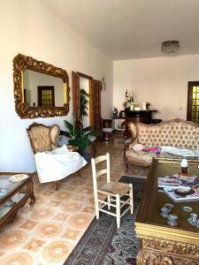 a living room with a couch and a table at Le Fresie B&B in SantʼAntìoco +18 photos