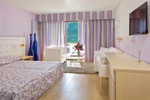 Rúm í herbergi á Hotel Ascona