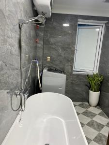 a bathroom with a white sink and a window at Khánh Phong Apartment in Waterfront in Hai Phong