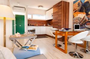 a kitchen with a desk and a table with a laptop at Maspalomas Beach Apartment Charca 1 in Maspalomas