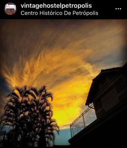 a painting of a palm tree against a cloudy sky at Casarão Petrópolis Vintage - Hostel & Suítes in Petrópolis