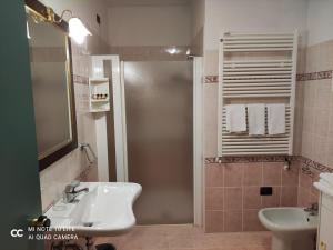 a bathroom with a shower and a sink and a sink at Val Del Rio in Fiumalbo +62 photos
