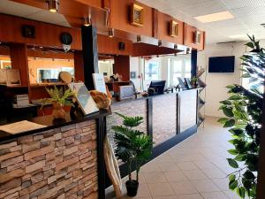 an office lobby with a counter with plants at Hotel Kulusuk in Kulusuk