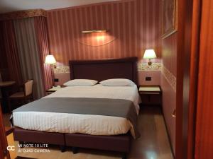 a bedroom with a bed with two pillows on it at Val Del Rio in Fiumalbo