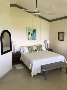 a bedroom with a bed and a ceiling fan at Hotel Playazul in Santa Cruz de Barahona