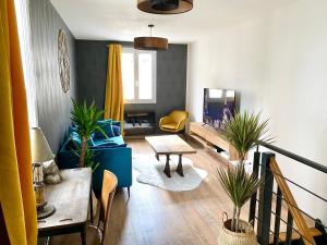 - un salon avec un canapé et une table dans l'établissement Maison cœur de ville esprit industriel - Le Loft12, à Châteauroux