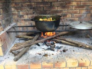 a pot sitting on top of a fire at LÉ FÈ COCO in Saint-Paul