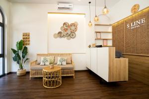 a lobby of a store with a couch and a table at Sline Hotel in Hue