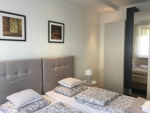 a bedroom with two beds and a mirror at Apartament na wydmie in Ustka