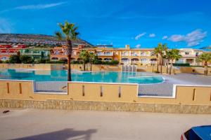 a large swimming pool in front of a resort at Margarida - holiday bungalow in peaceful surroundings in Benitachell in Benitachell