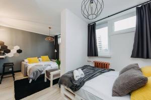 a bedroom with two beds and a window at 4Eco Apart Charm Grzybowska City Center in Warsaw