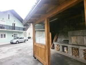 a building with a garage with a fire place at Guest House Potok in Lokve