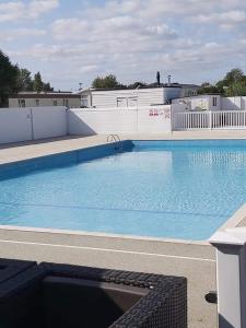a large swimming pool with blue water at Yare Village, Breydon water holiday park in Great Yarmouth