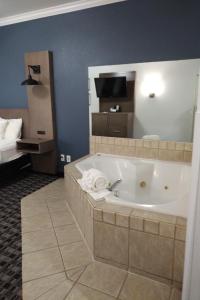 a large bath tub in a room with a bed at La Quinta by Wyndham Dalhart in Dalhart