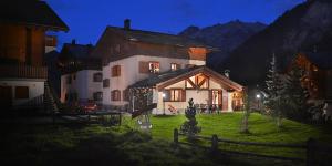a large house with a fence in front of it at Chalet Barbara in Livigno