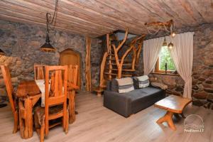 a living room with a couch and a table at Stone house in Prapuntai