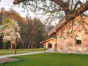 a stone building in a park with green grass at Stone house in Prapuntai