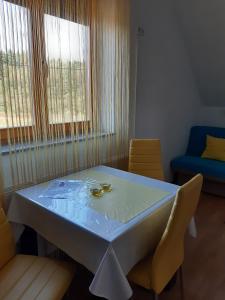 a room with a table with two chairs and a bed at House Matijević Šimić in Grabovac