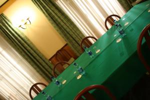 a green table with glass doors on top of it at Albert Hotel in Milan