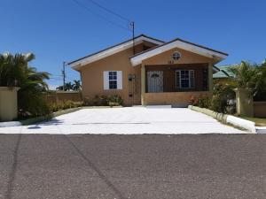 a house with a large driveway in front of it at Bing's Home Away From Home in Ocho Rios