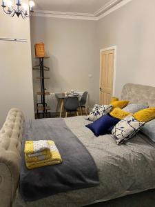 a bedroom with a bed with pillows and a table at Cambridge Villas Private Studio Lytham St Annes in Saint Annes on the Sea