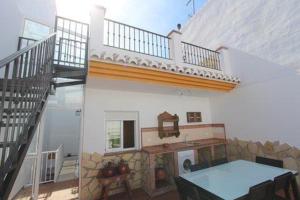 a room with a table and a staircase in a house at Casa María en el centro Nerja in Nerja