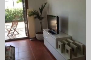 a living room with a tv on top of a dresser at Casa Esparto in Rodalquilar