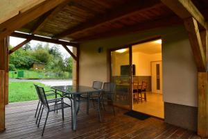 a patio with a table and chairs on a deck at Bungalov v Beskydech in Frenštát pod Radhoštěm