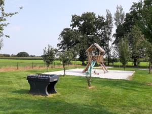 a playground in a park with a playset at Kalmthoutse Hoeve in Kalmthout