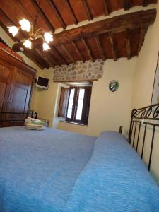 sypialnia z niebieskim łóżkiem w pokoju w obiekcie Casina nel Borgo w mieście Pari